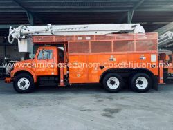 2001 INTERNATIONAL 4900 CAMION BARRENADOR CON CANASTILLA b